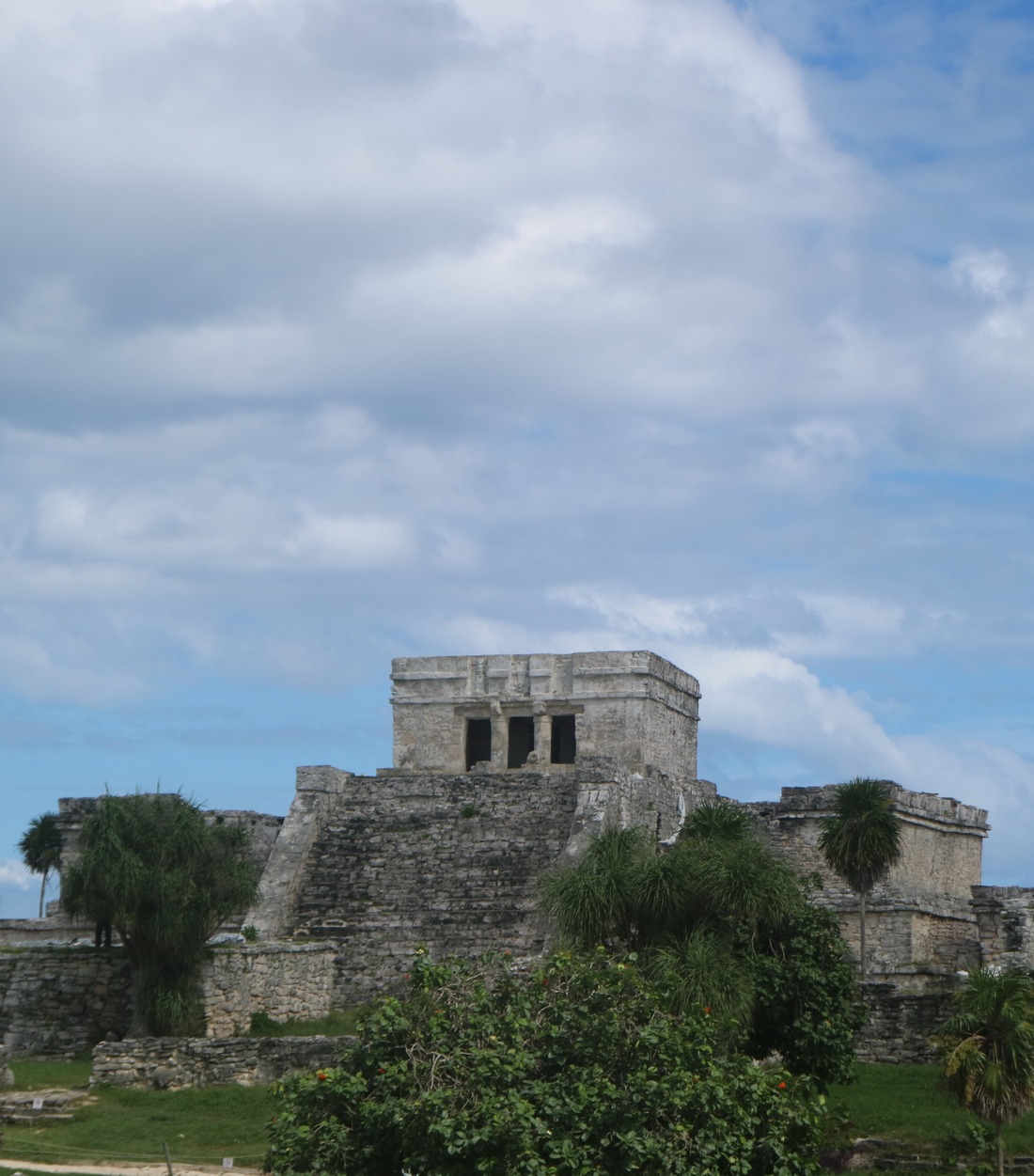 El Castillo temple at the Tulum archaeological site under a cloudy sky