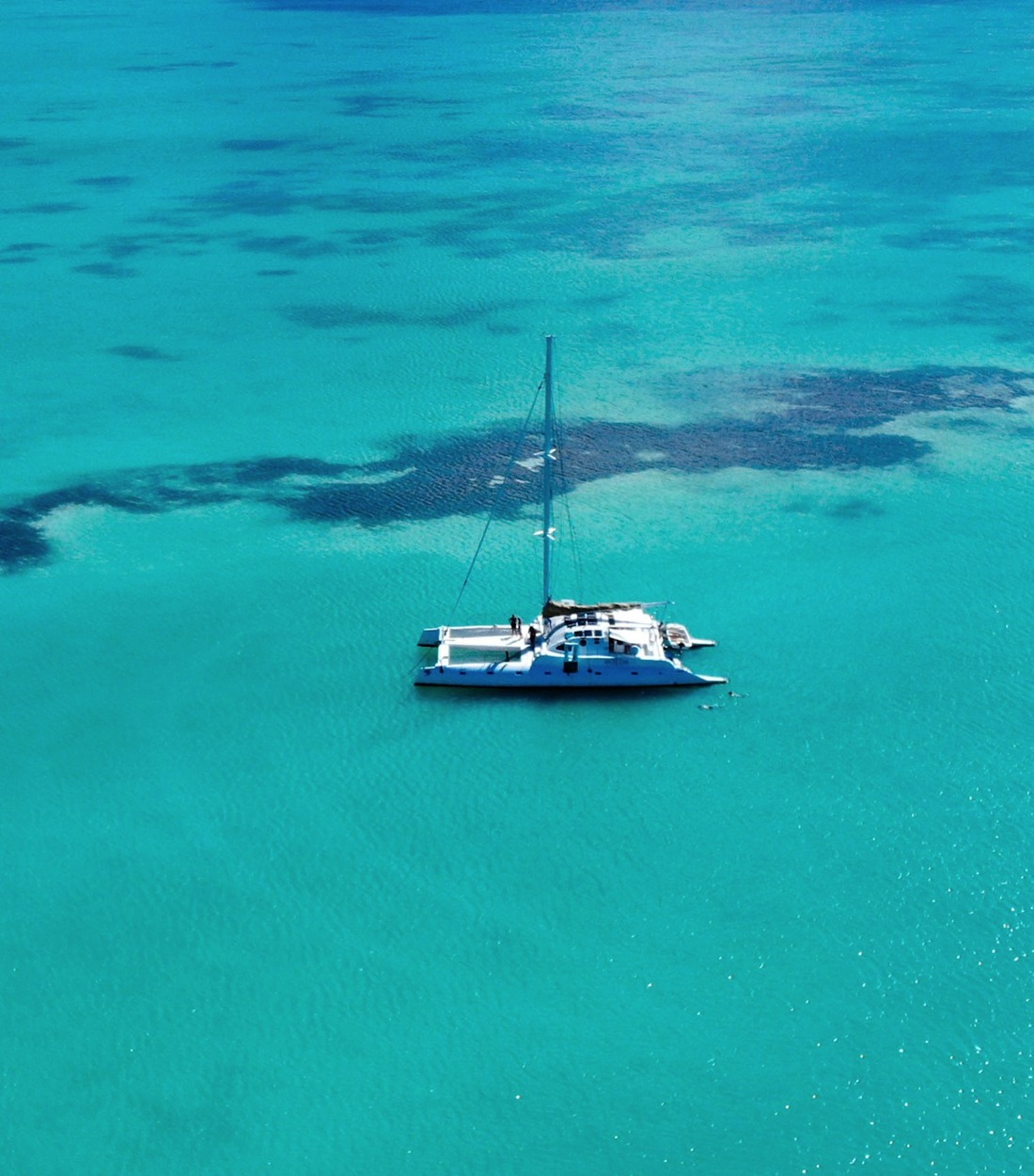 Catamaran anchored on bright turquoise water