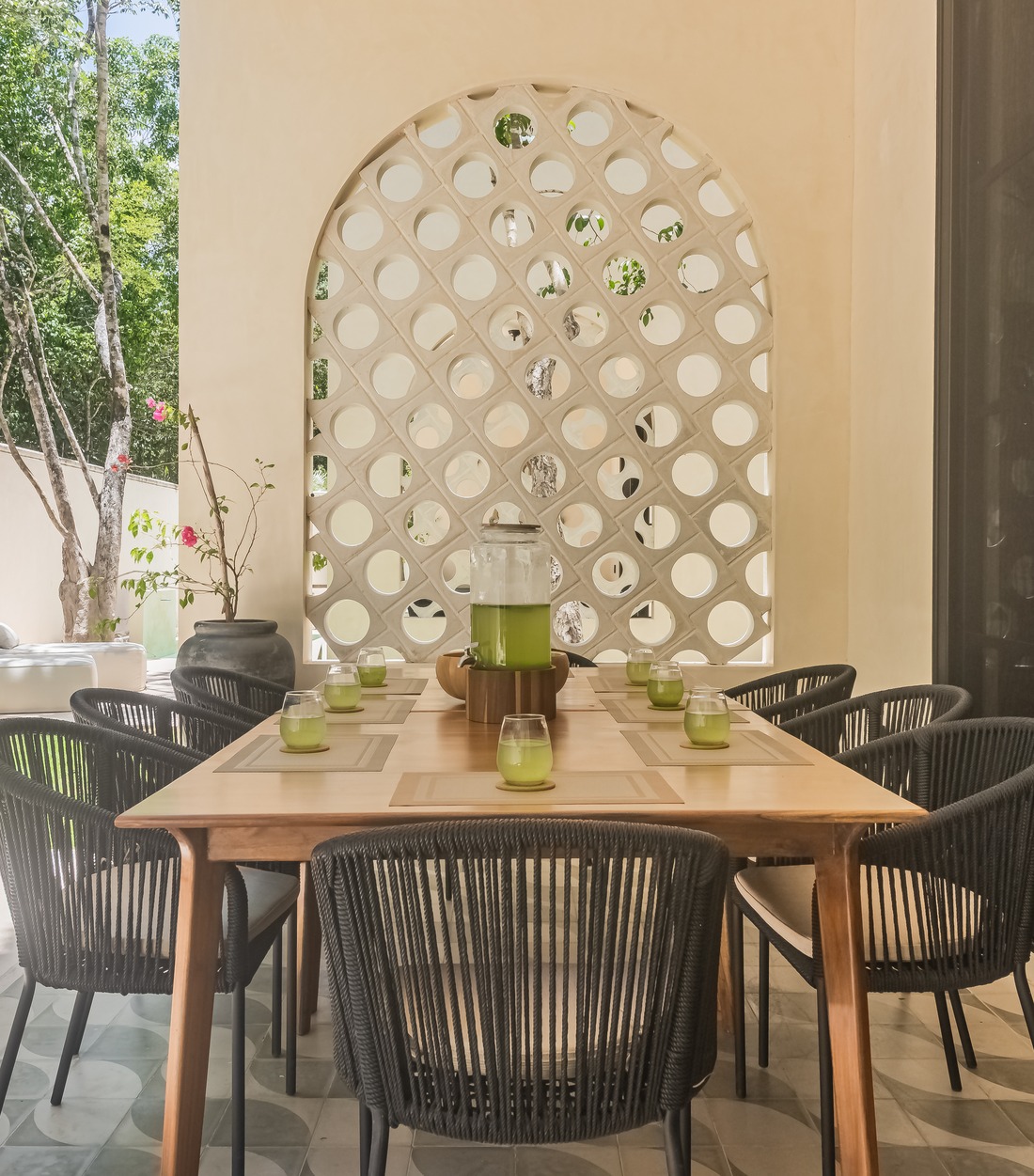 Long dining table at the villa set with fresh green juices
