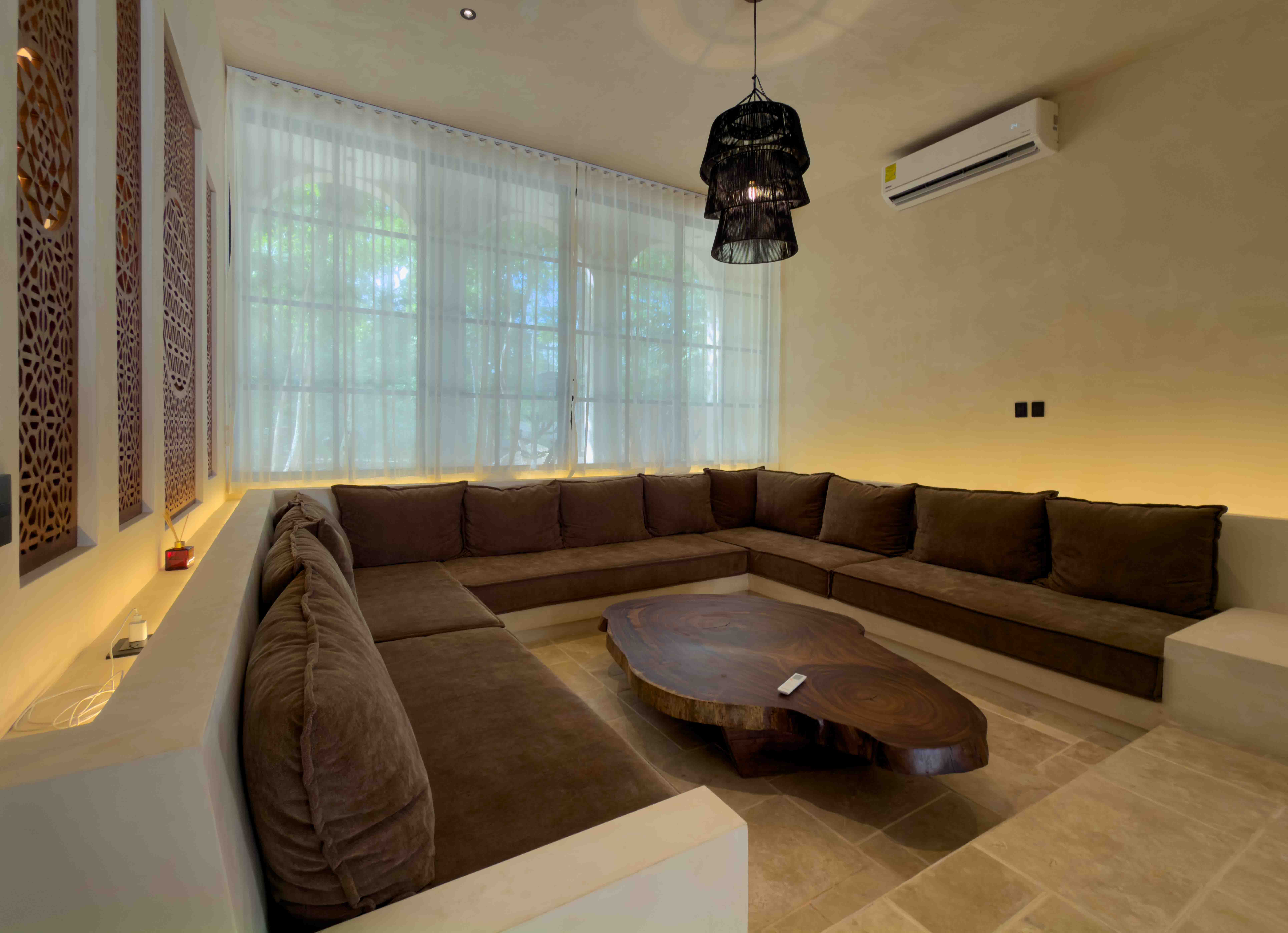 Sunken indoor lounge area with a live-edge coffee table and built-in seating.
